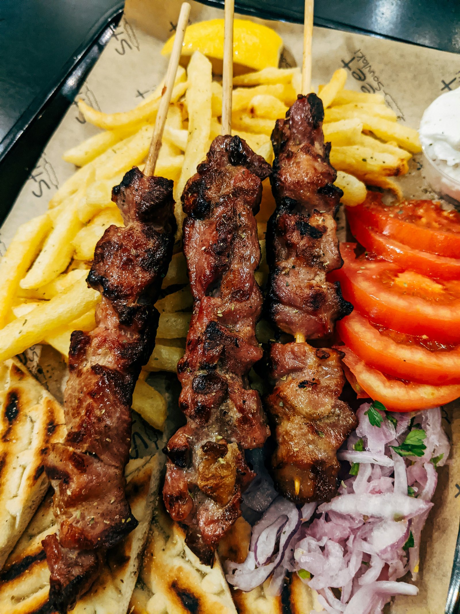 threading marinated chicken on skewers